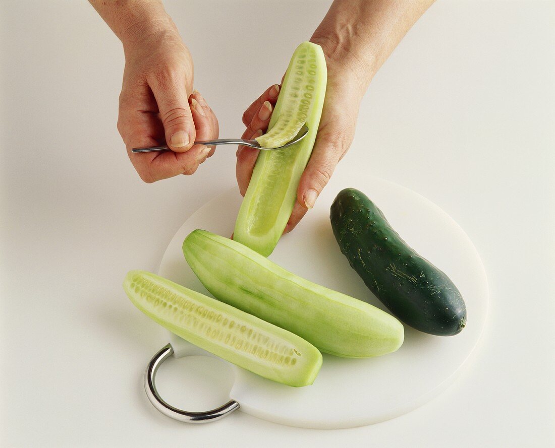 Deseeding a cucumber with a spoon
