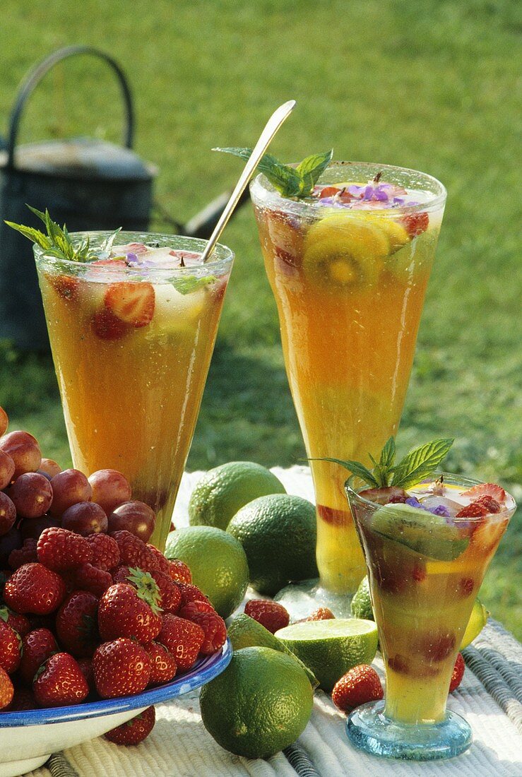 Summery fruit drink in three glasses out of doors