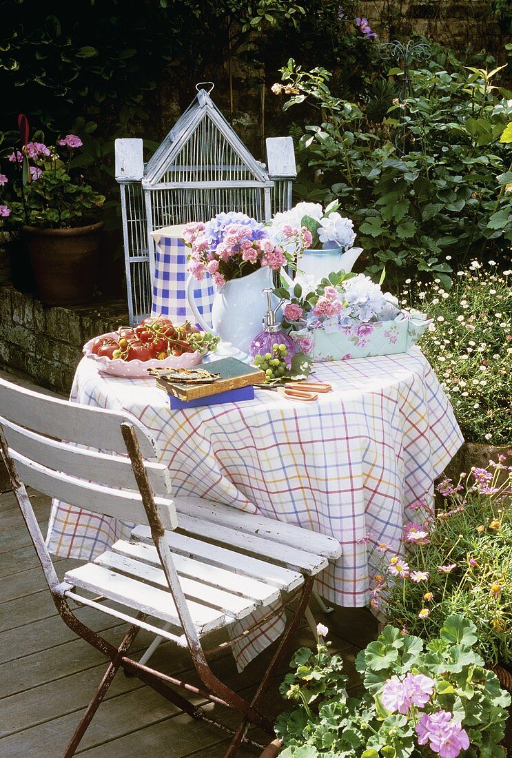 Tomatoes and roses on garden table