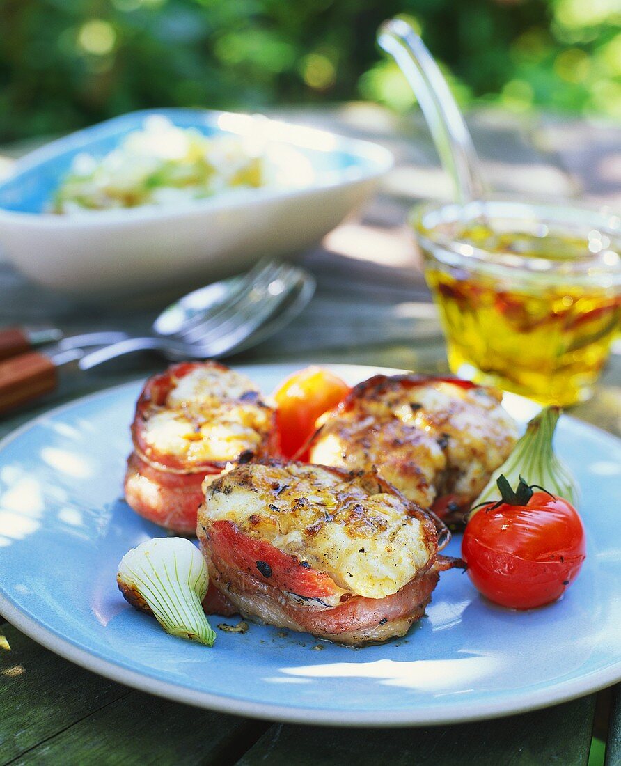 Bacon-wrapped pork medallions with cheese topping