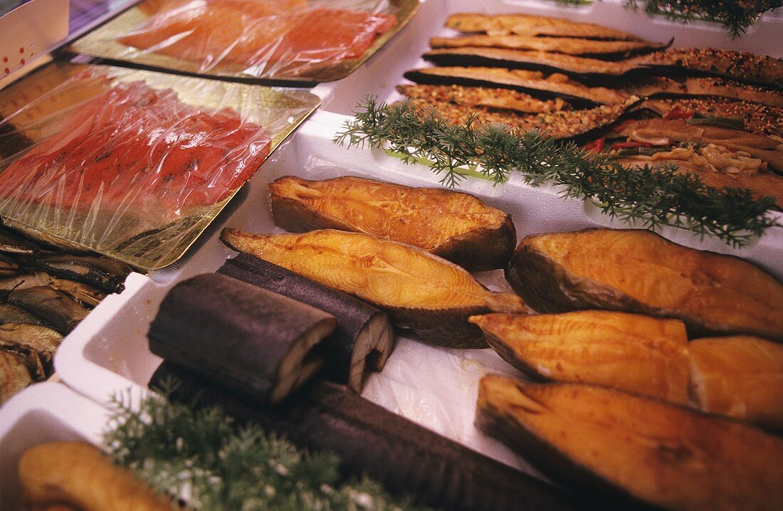 Various kinds of smoked fish on a counter