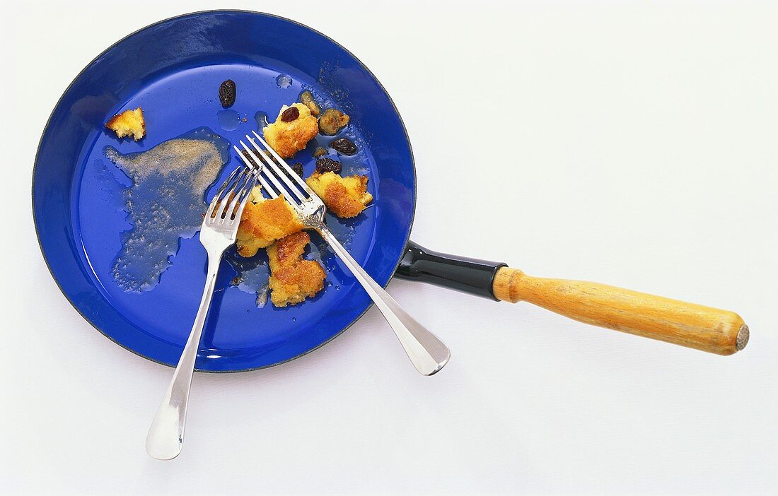 Frying pan with remains of Kaiserschmarrn (shredded pancake)