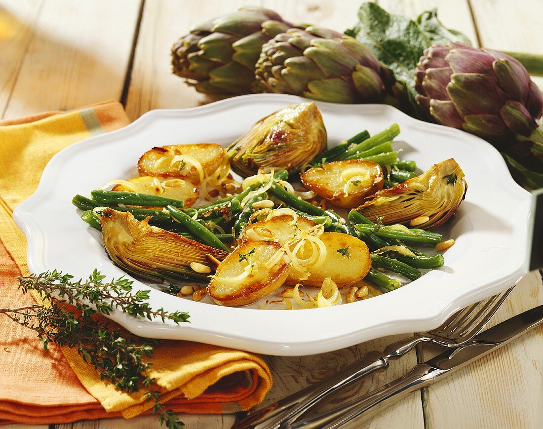 Roasted potato halves with green beans and artichokes