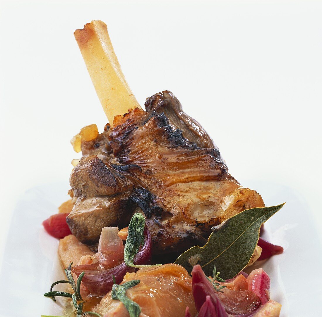 Lamb shank on apples and herbs
