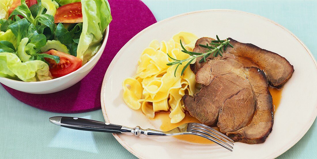 Marinated leg of wild boar with ribbon pasta and salad