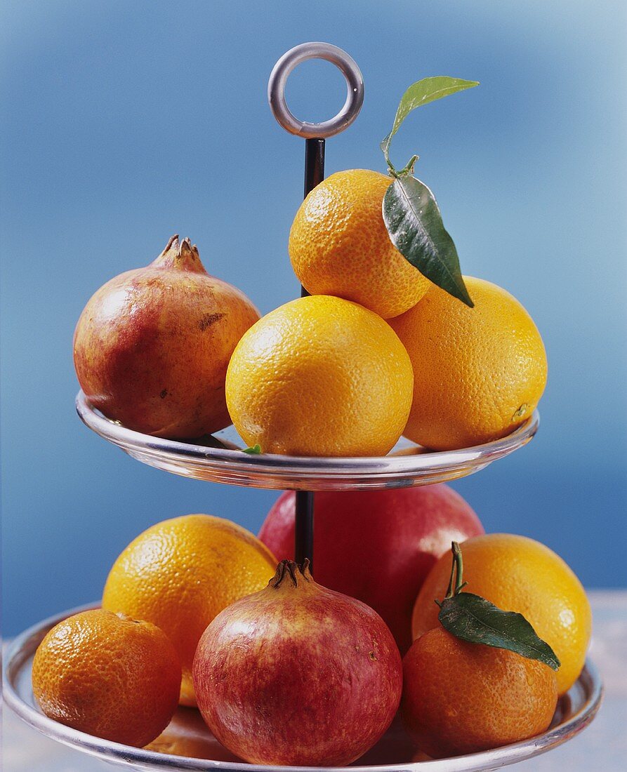 Citrus fruit and pomegranates on tiered stand