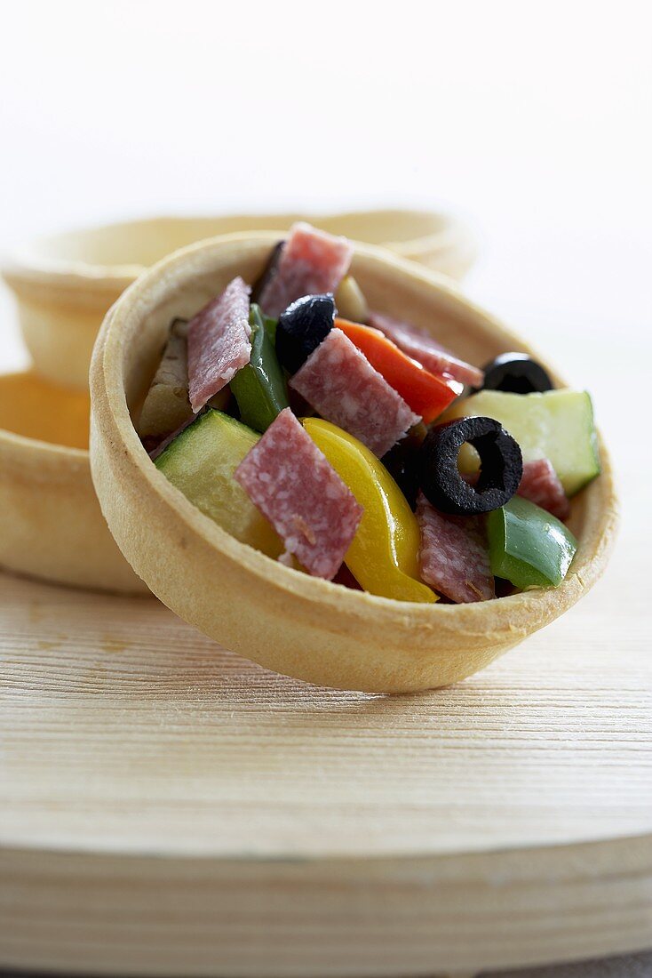 A salami, pepper and olive tartlet