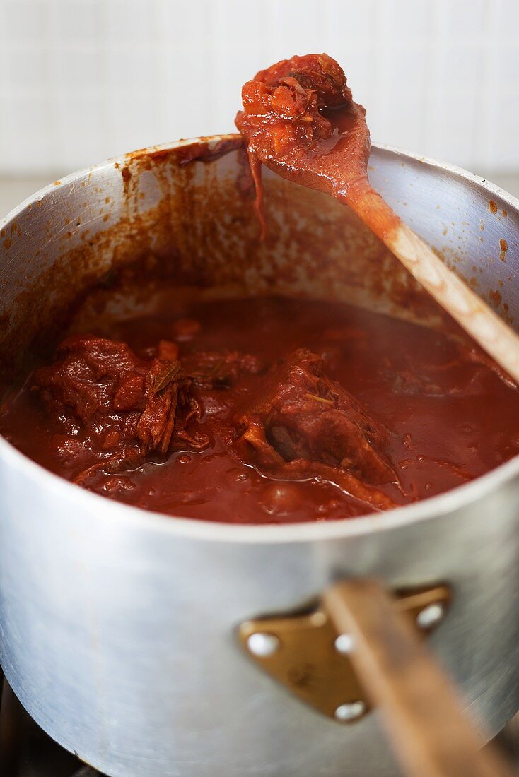 A pot of lamb stew with tomatoes