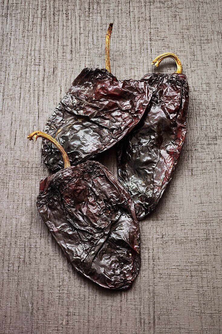 Three dried Poblano chili peppers