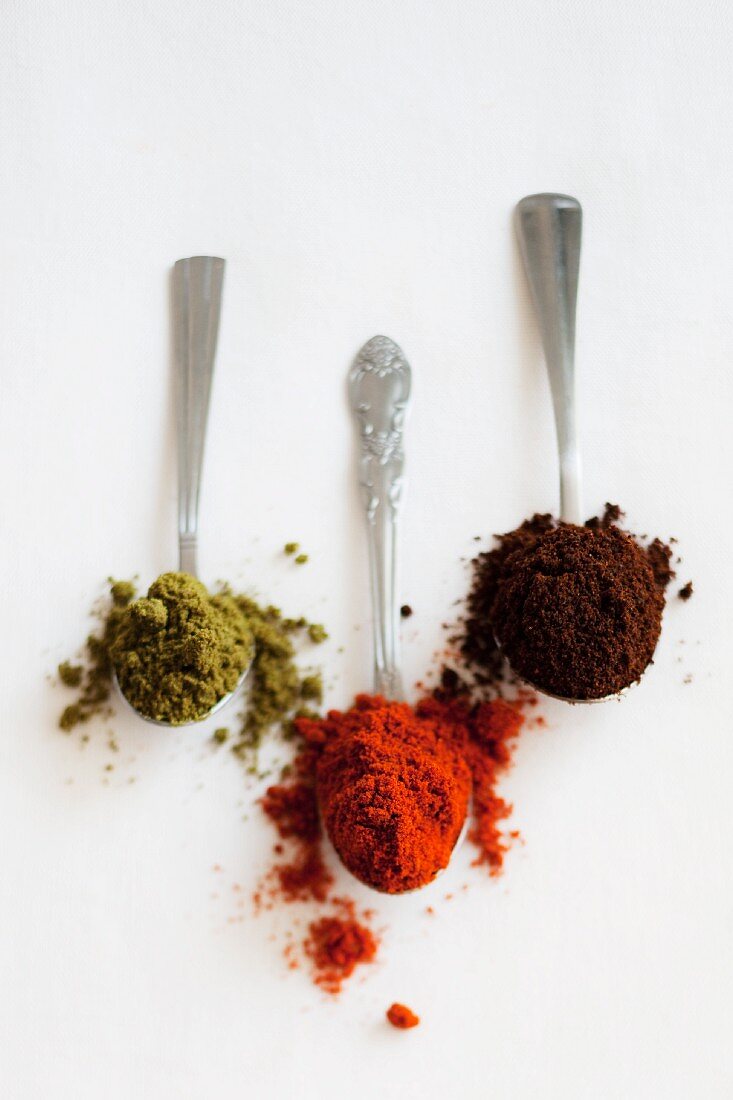 Three spoons with different spice mixtures