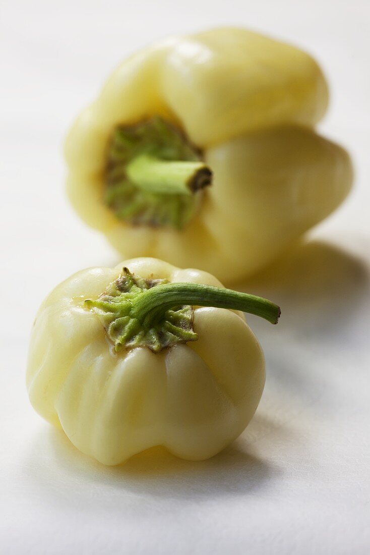 Two pale yellow peppers