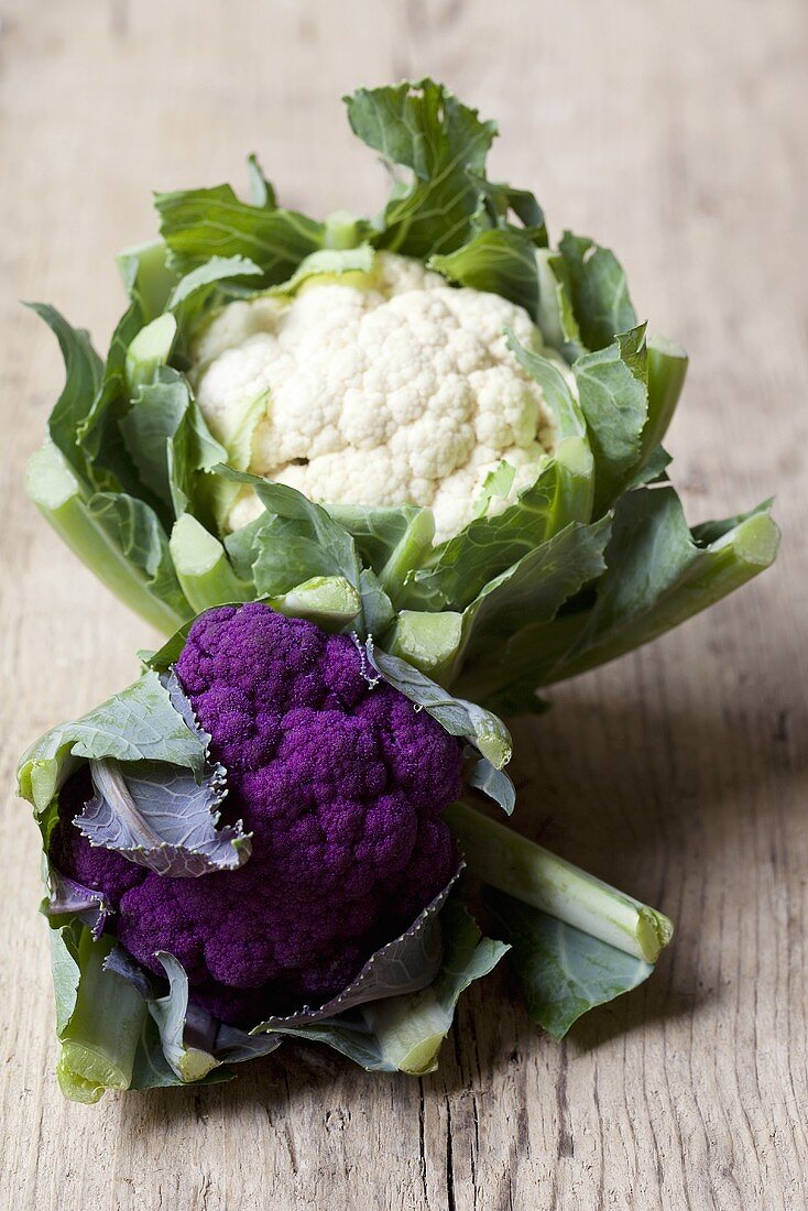 A cauliflower and a purple cauliflower