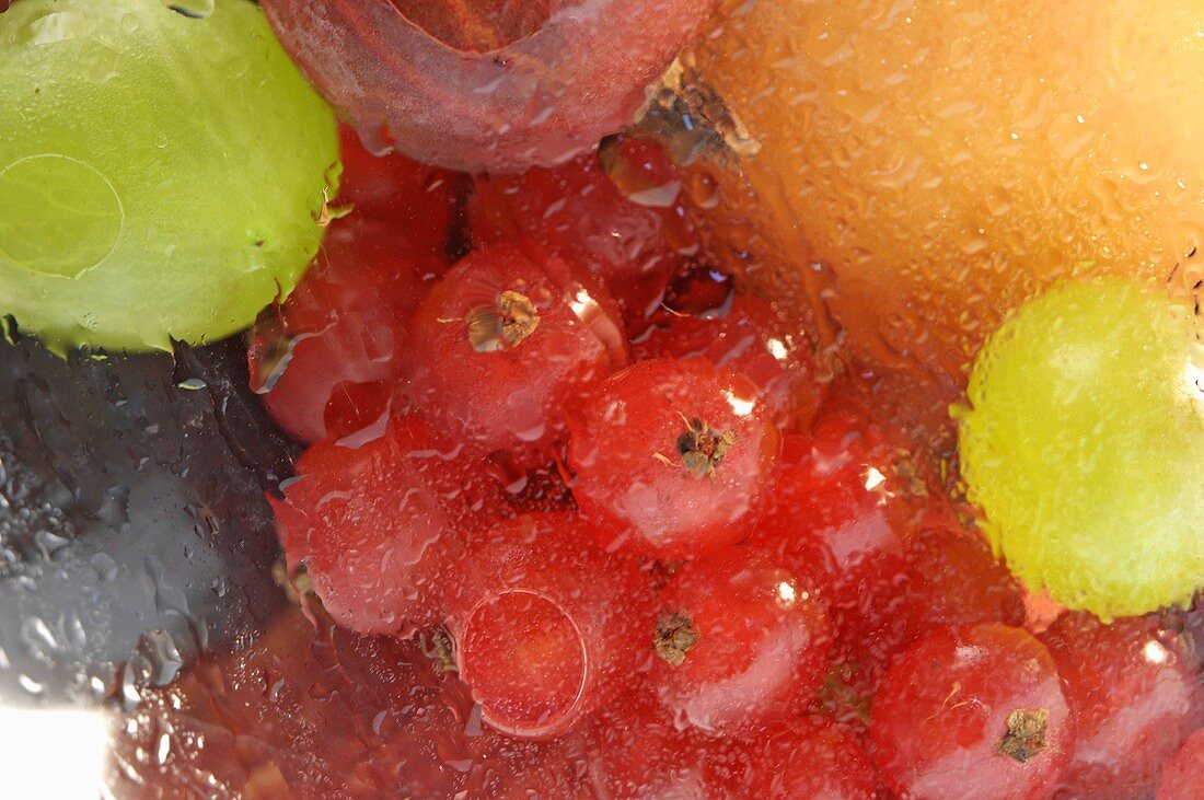 Various types of fruit in a misted glass (close up)