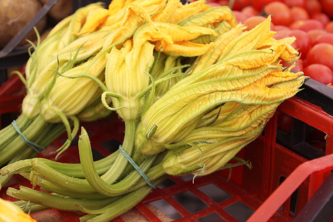 Courgette flowers in a crate at the market
