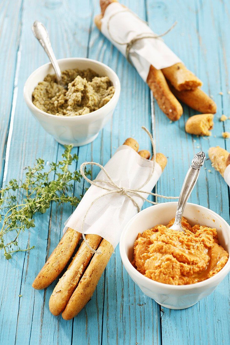 Spicy cheesy bread sticks with a pepper dip and tapenade