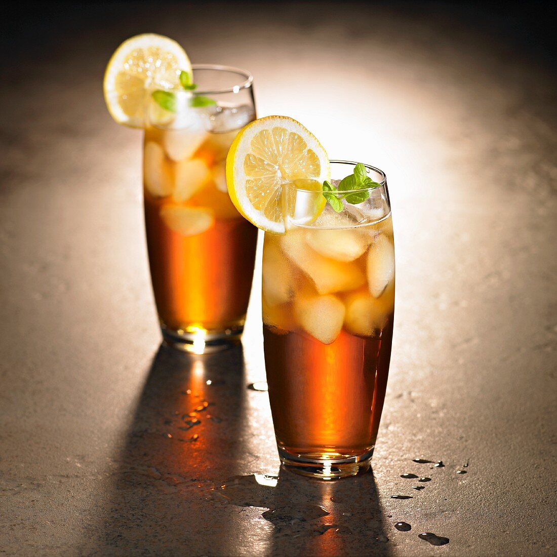 Rum and cola with ice cubes and lemons