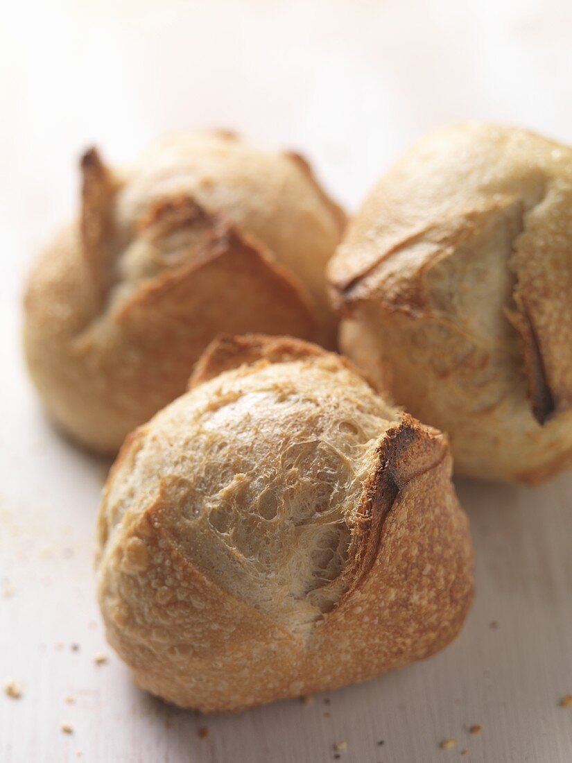 Three freshly baked bread rolls (close up)