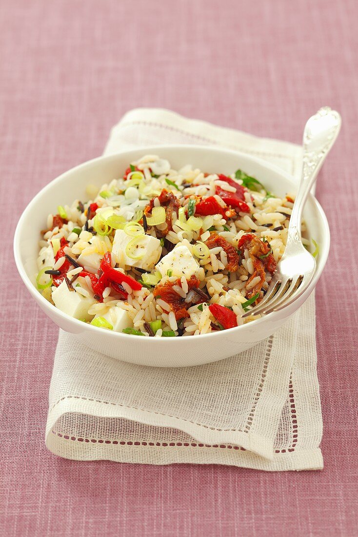 Rice salad with peppers, dried tomatoes, feta and herbs