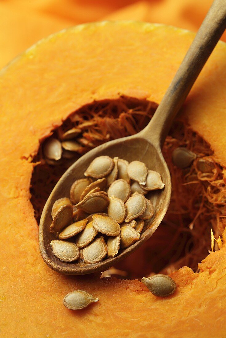 Pumpkin seeds on a wooden spoon