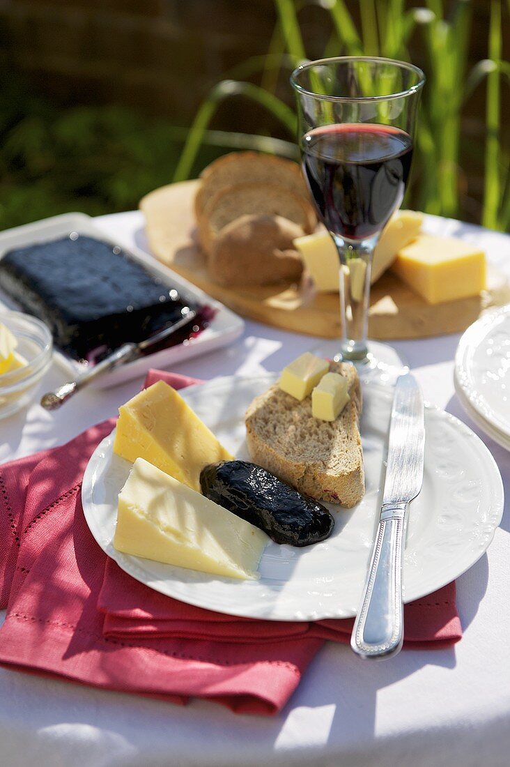 Cheese, bread, butter and blackcurrant jam