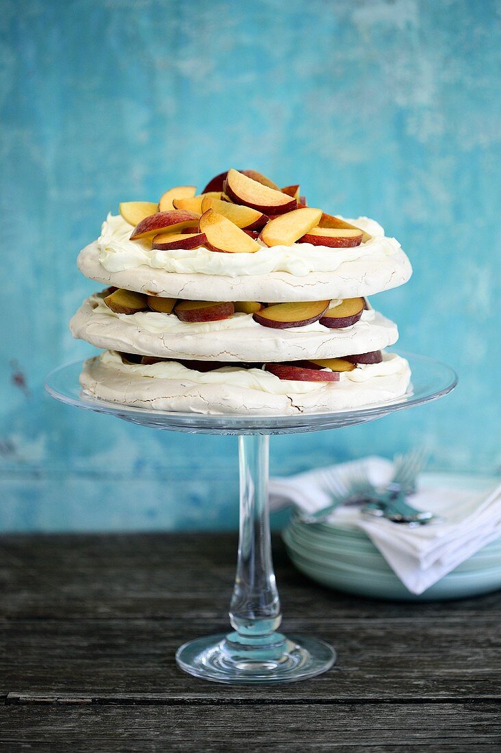 Pavlova with nectarines on a cake stand