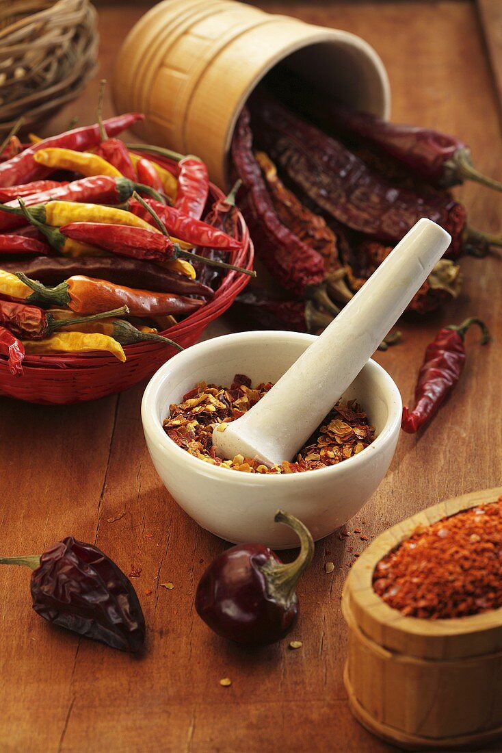 Various dried chilli peppers and chilli flakes
