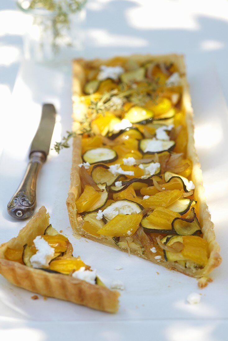 Courgette and pepper tart, sliced