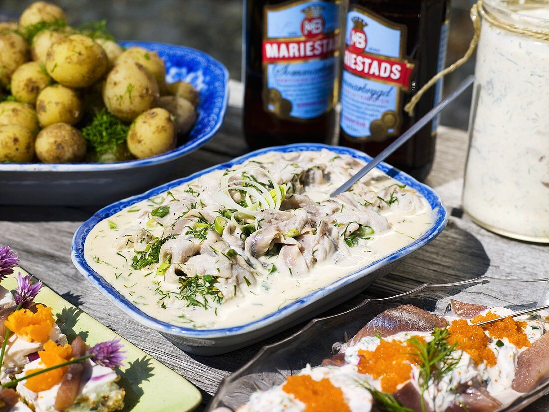 Buffet mit verschiedenen Heringsgerichten und Dillkartoffeln