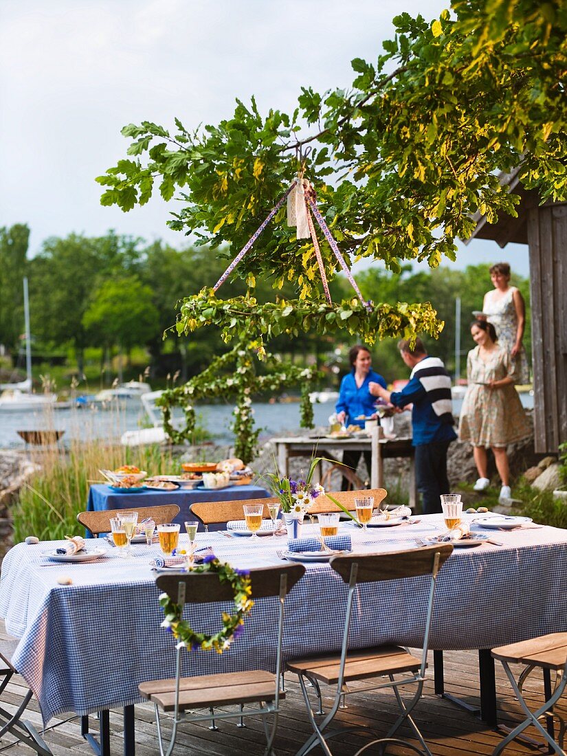 A buffet and a table laid for a midsummer party (Sweden)