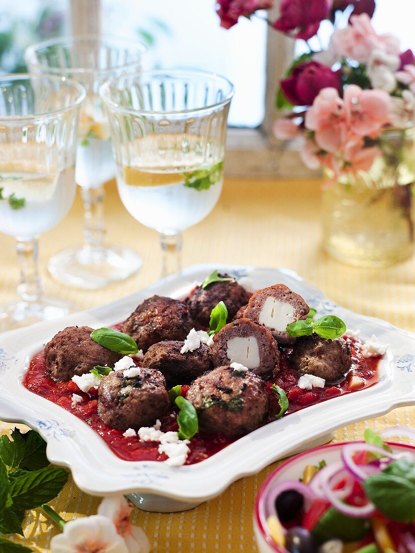 Lamb balls stuffed with feta on a tomato sauce