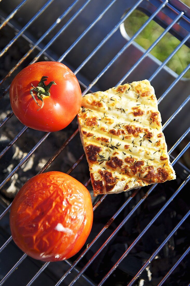 Cheese and tomatoes on a barbeque