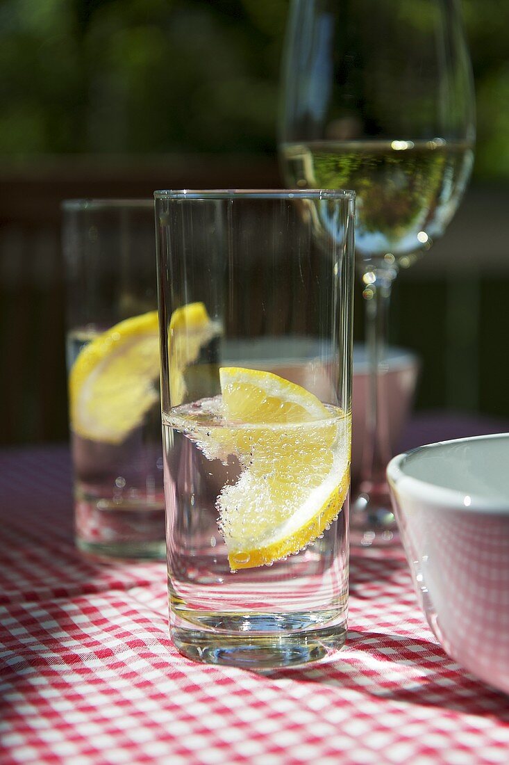 A glass of mineral water with a slice of lemon