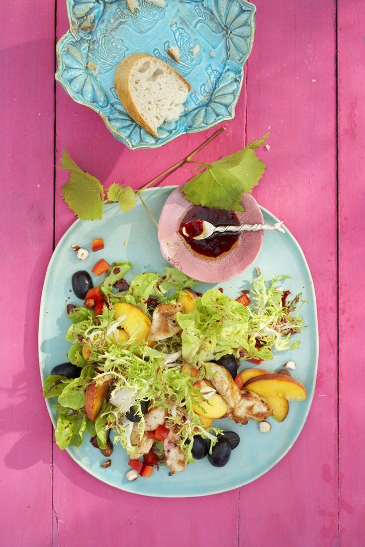 Salad leaves with chicken, fruit and fruity dressing