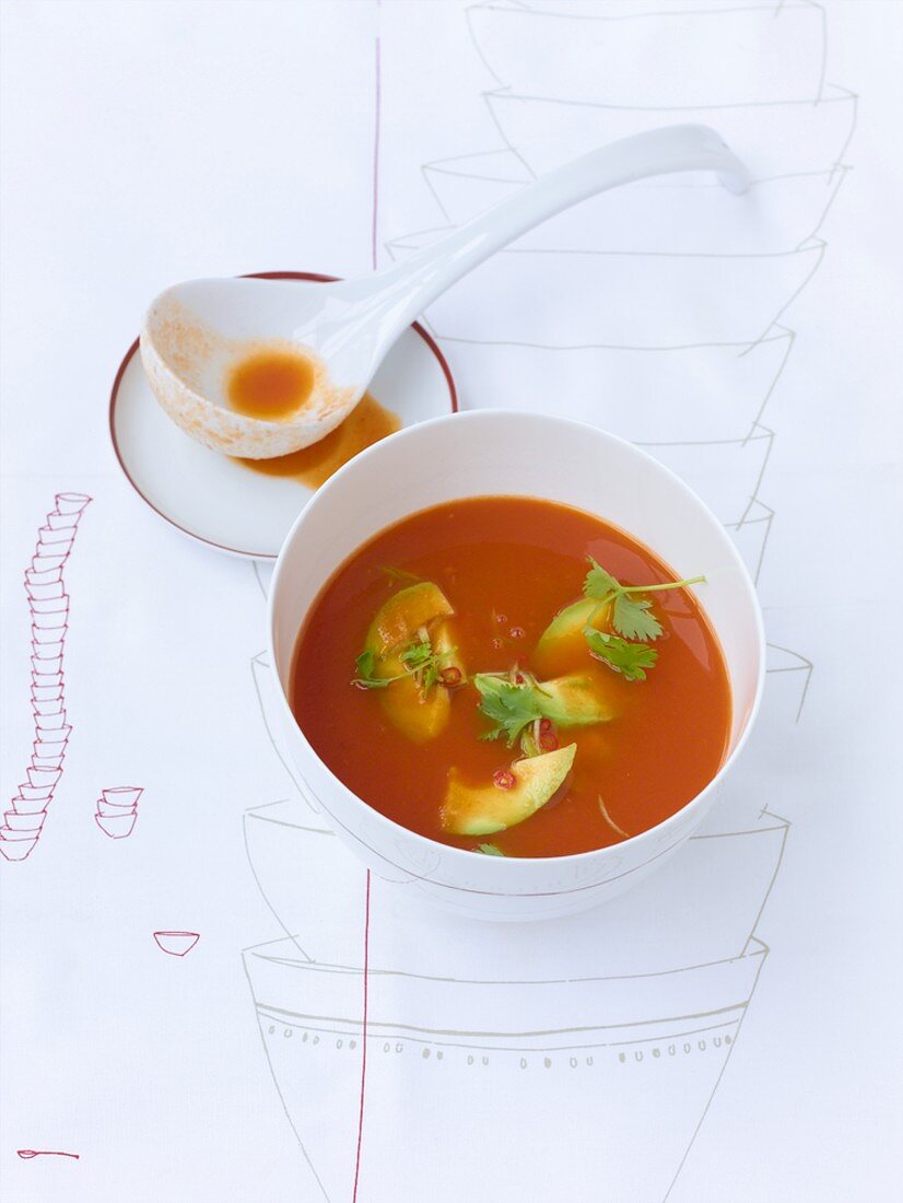 Tomato soup with avocado and chilli salsa, ladle