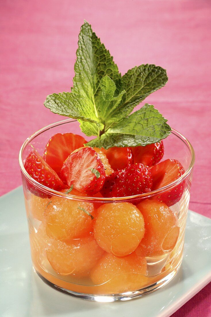 Melon and strawberry salad with mint in a glass