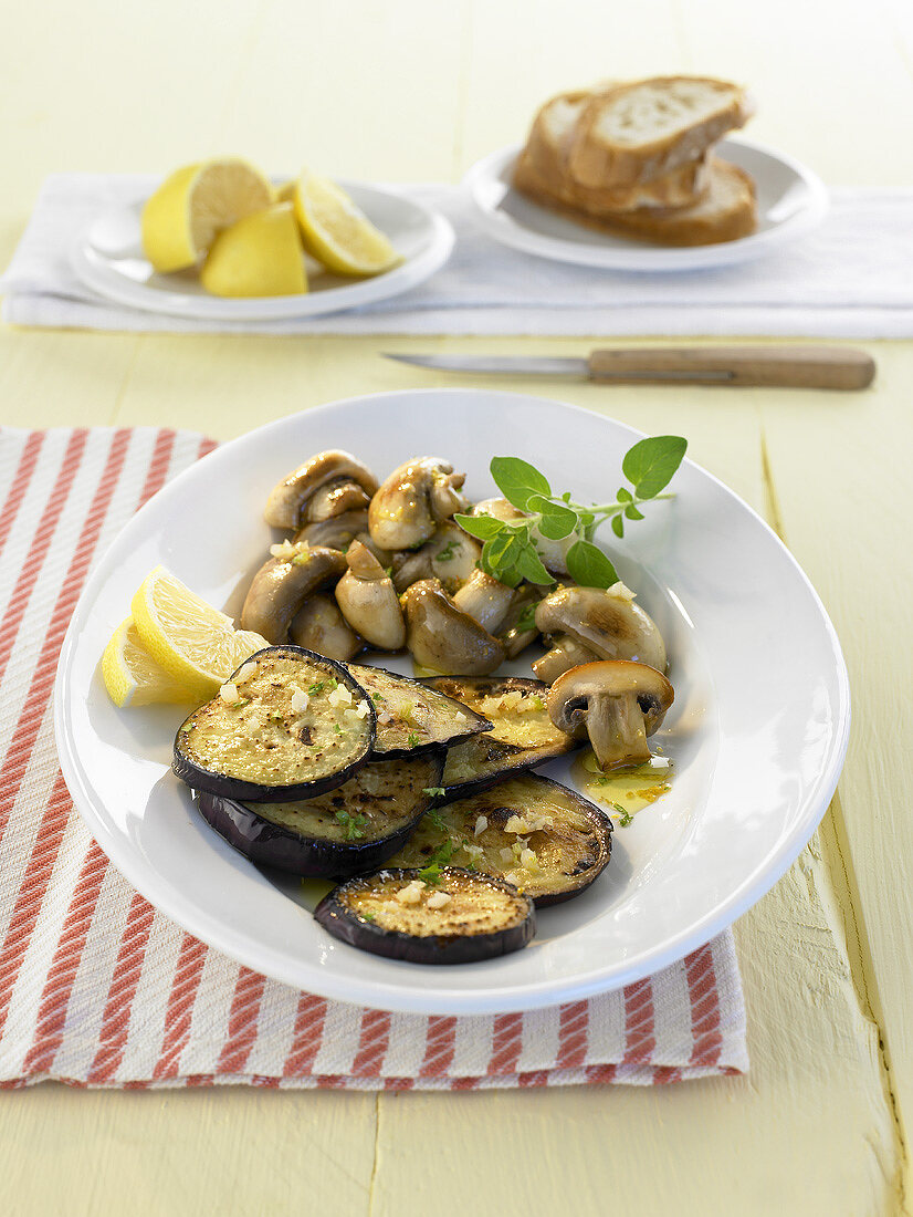 Marinated aubergines and mushrooms with baguette and lemon