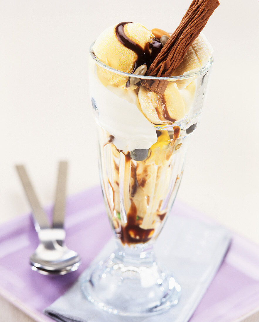 Vanilla ice cream sundae with banana and chocolate sauce