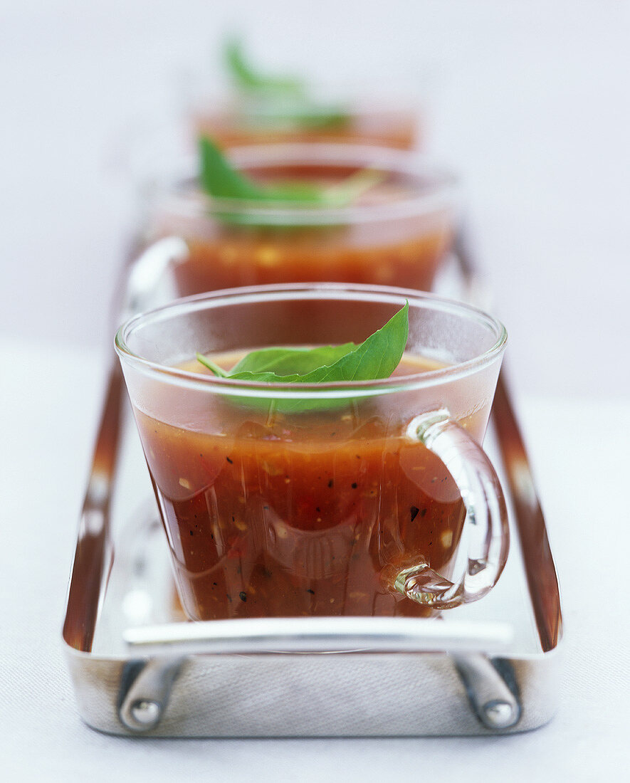 Tomato and pepper soup in three glass cups