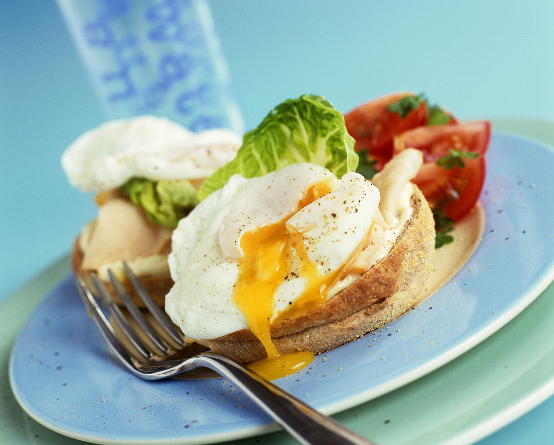 Bagel topped with poached egg, lettuce and tomato