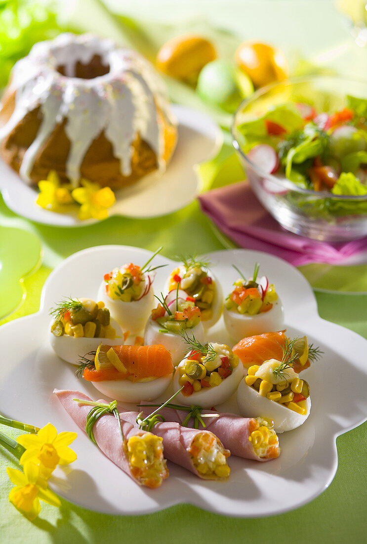 Stuffed eggs and ham rolls on an Easter table