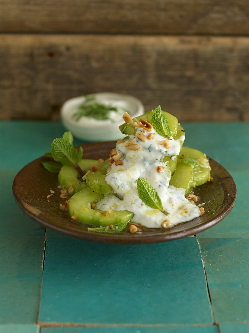 Braised cucumber with pine nuts and minted yoghurt