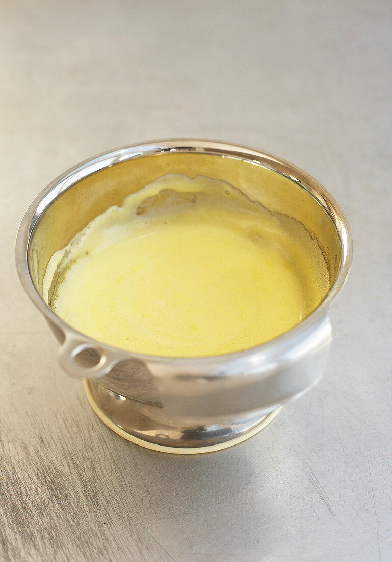 Hollandaise sauce in a mixing bowl