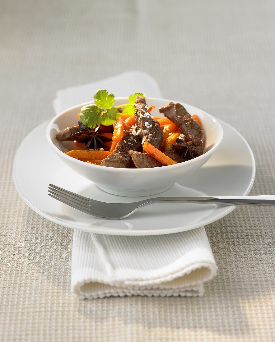Fried strips of beef fillet, carrots, star anise & grated coconut