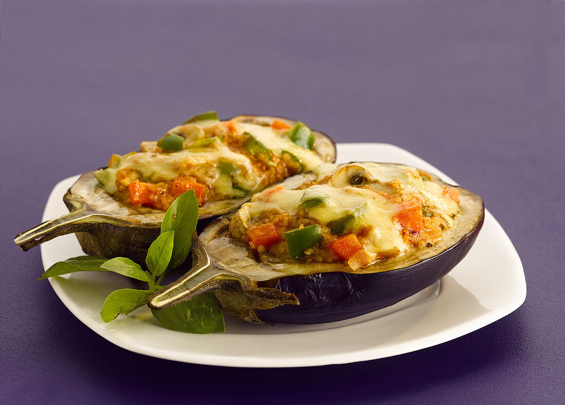 Stuffed aubergines with melted cheese topping (India)