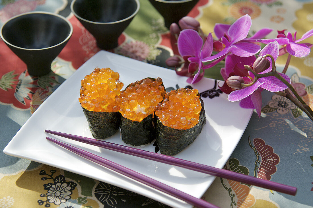 Three maki sushi with salmon caviar