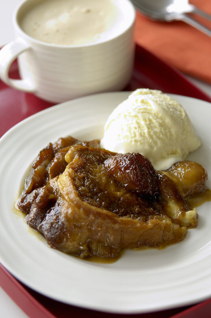 Portion of banana raisin bread pudding, vanilla ice cream & coffee