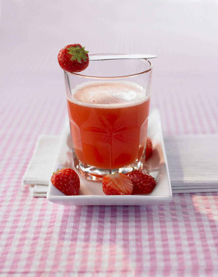 A glass of strawberry and passion fruit drink