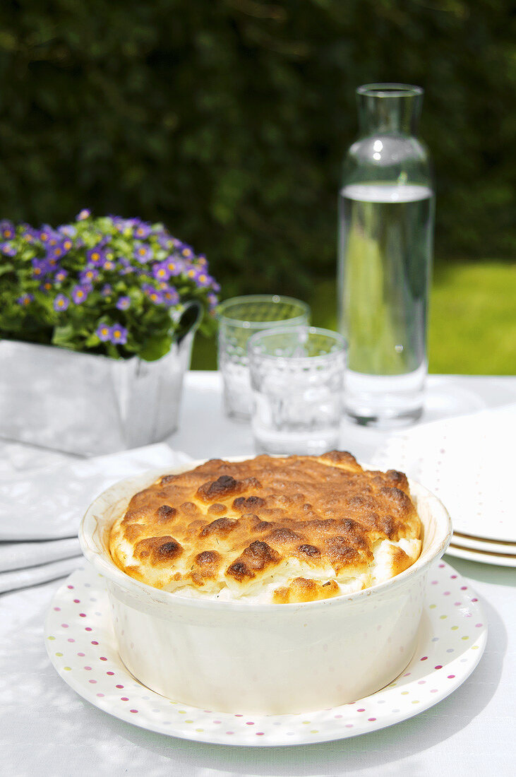 Herb soufflé in a baking dish out of doors