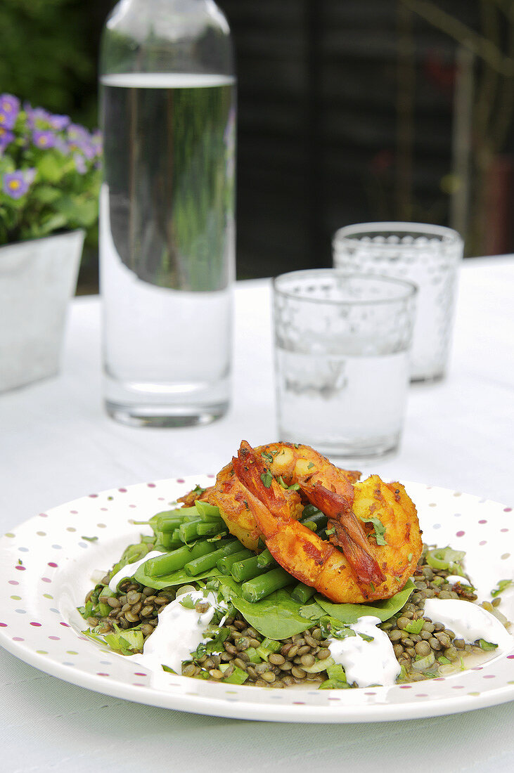 Fried prawns on lentils and beans