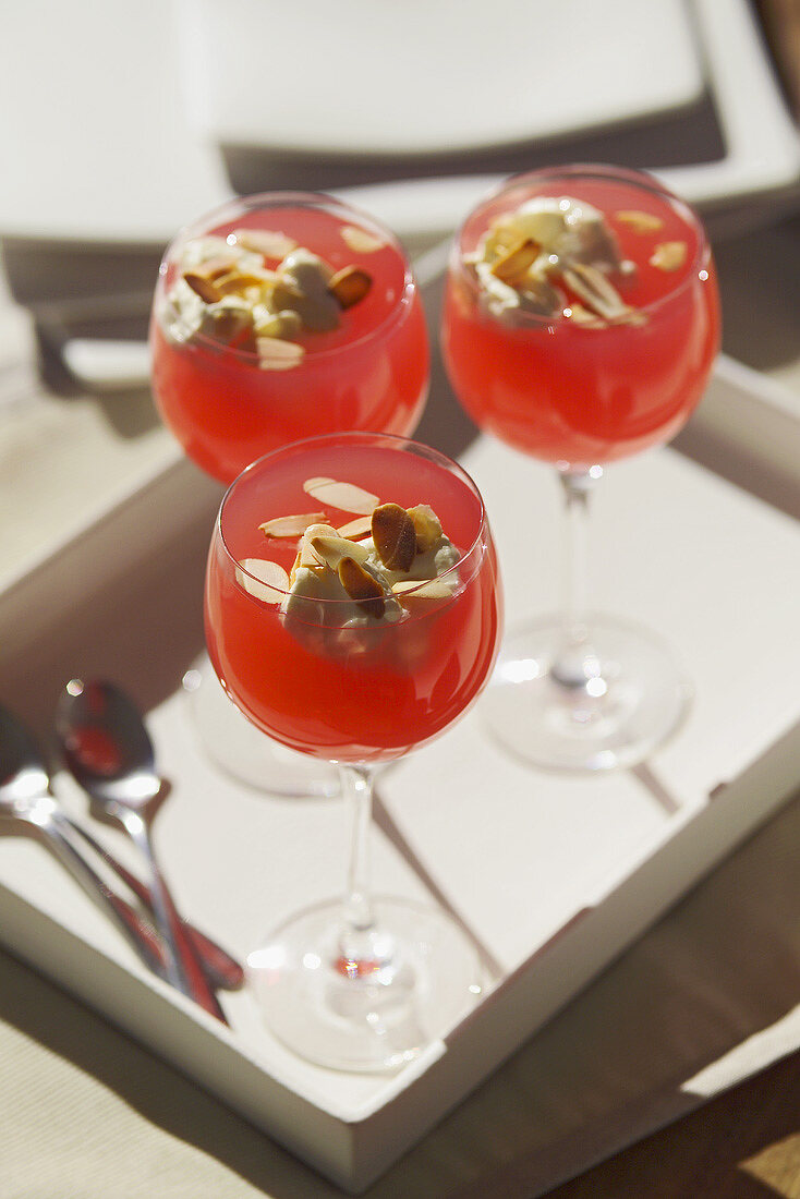 Rhubarb & honey jelly with flaked almonds in three glasses